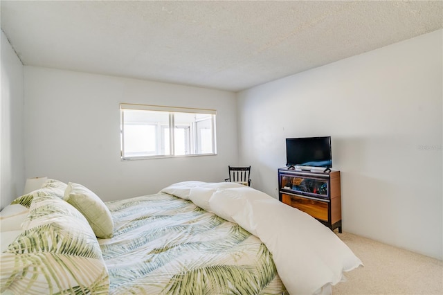 bedroom featuring a textured ceiling and carpet floors