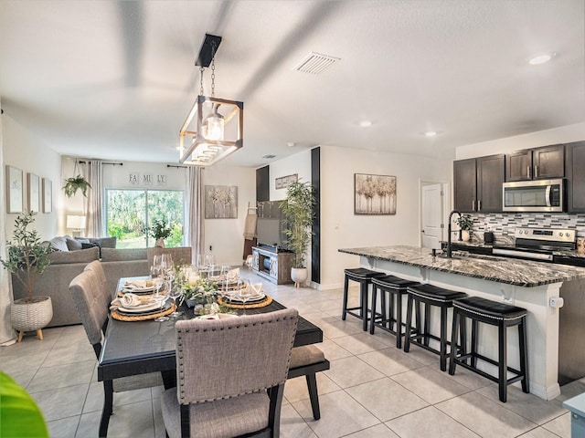 tiled dining area featuring sink