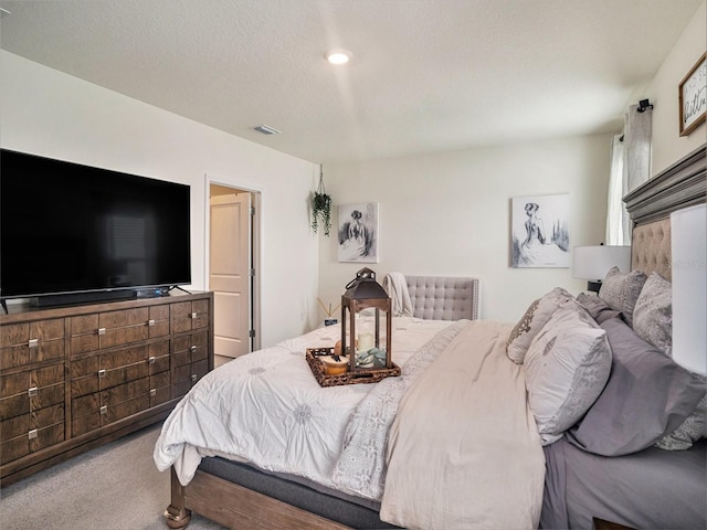 carpeted bedroom featuring a textured ceiling