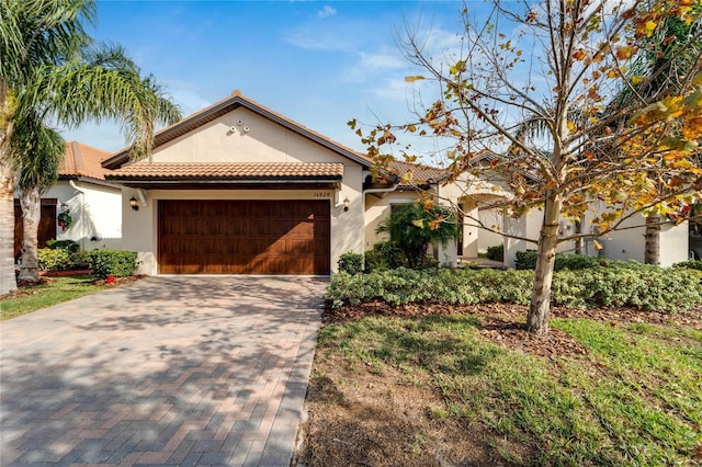 mediterranean / spanish-style home with a garage