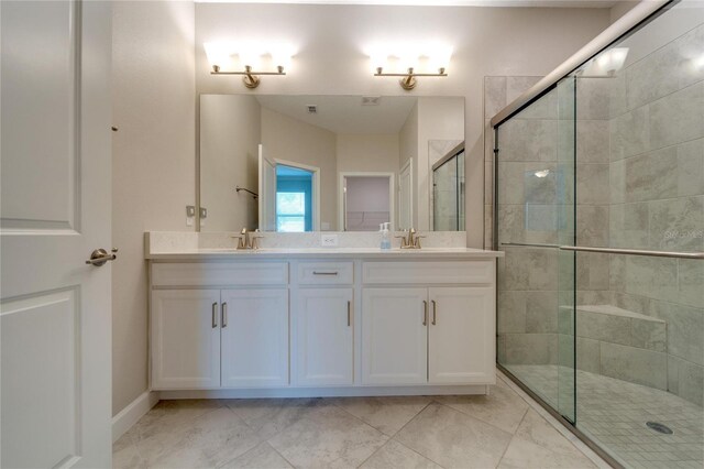 bathroom with tile patterned floors, vanity, and walk in shower