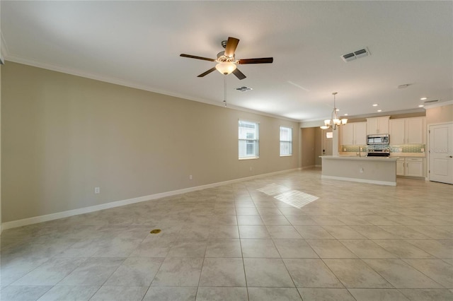 unfurnished living room with ceiling fan with notable chandelier, crown molding, and light tile patterned flooring