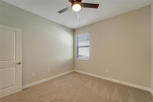 unfurnished room with ceiling fan and light colored carpet