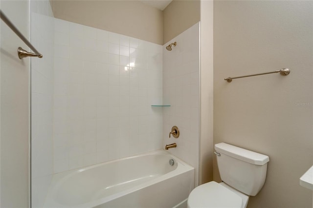 bathroom with shower / bathing tub combination and toilet