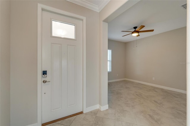 tiled entrance foyer with ceiling fan and crown molding