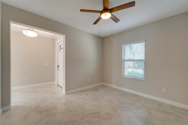 tiled empty room featuring ceiling fan