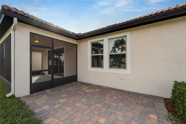 view of patio with a sunroom