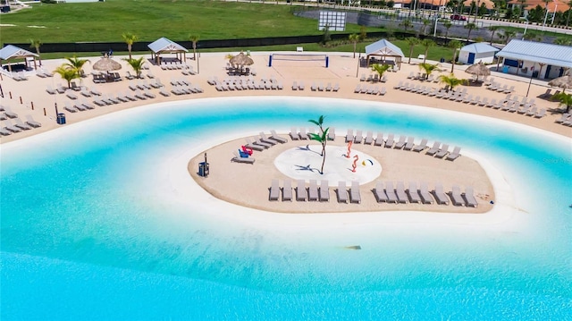 view of swimming pool with a beach view