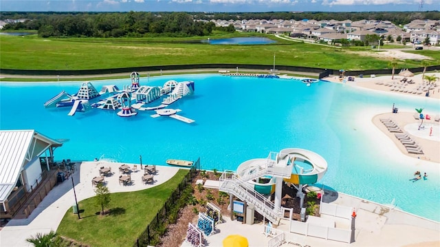 view of swimming pool featuring a water view