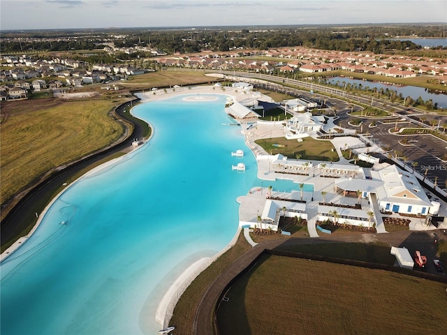 drone / aerial view with a beach view and a water view