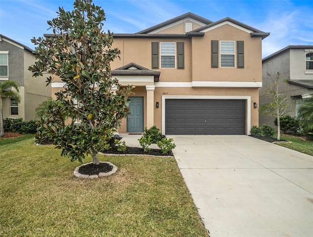 view of front of property with a front lawn and a garage