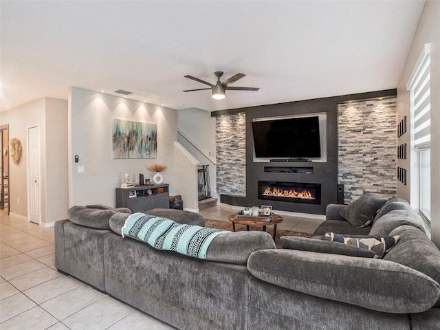 living room featuring ceiling fan and light tile patterned floors