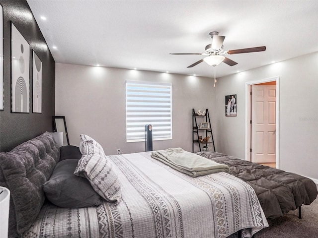 bedroom featuring ceiling fan and carpet