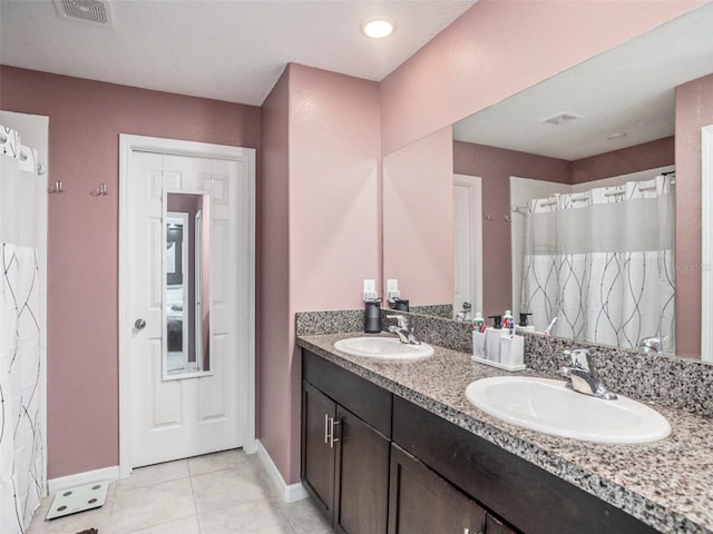 bathroom featuring tile patterned flooring and vanity