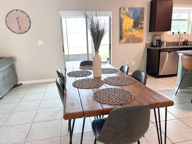 tiled dining area featuring sink