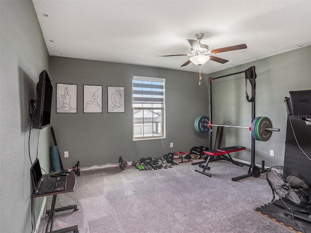 exercise room with ceiling fan and carpet