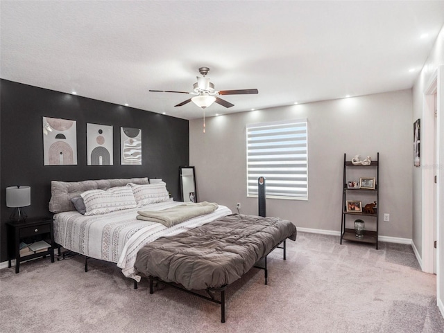 bedroom featuring ceiling fan and light carpet