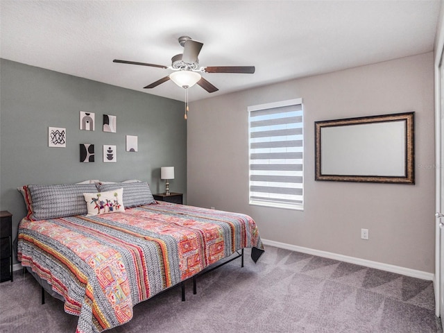 bedroom featuring ceiling fan and carpet