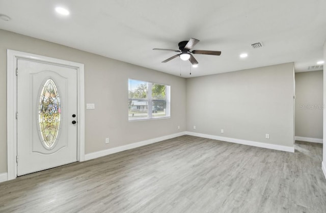 foyer with light hardwood / wood-style flooring and ceiling fan