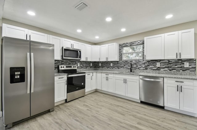 kitchen with white cabinets, sink, and appliances with stainless steel finishes