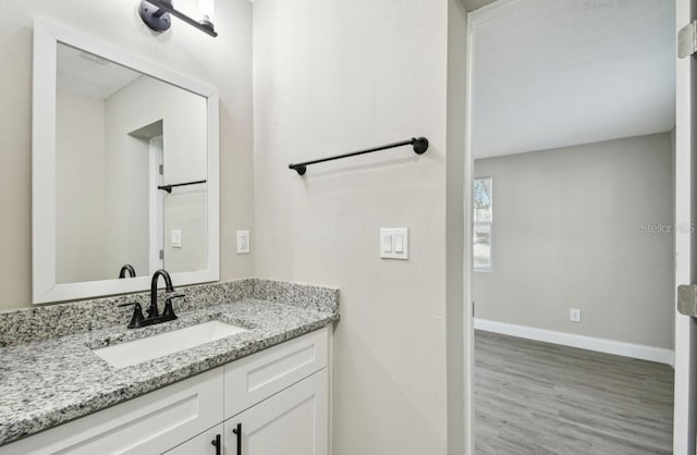 bathroom featuring hardwood / wood-style floors and vanity