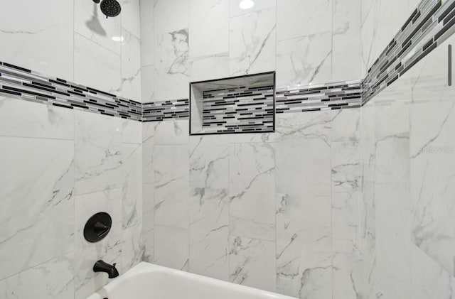 bathroom featuring tiled shower / bath