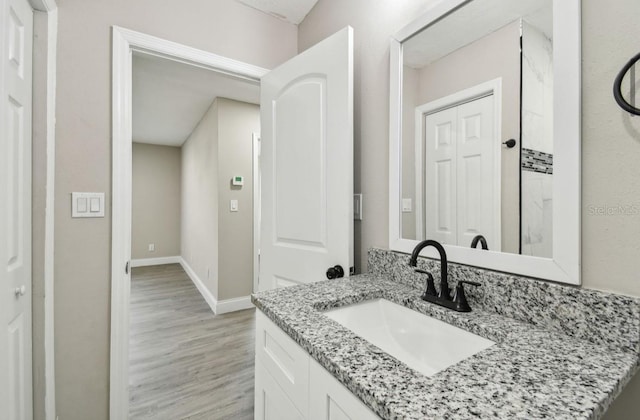 bathroom with vanity and wood-type flooring