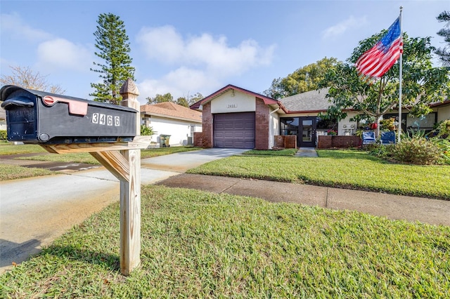 view of front facade with a garage and a front yard