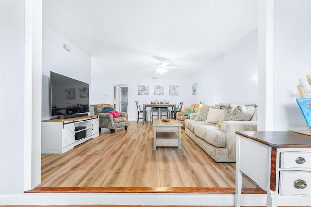 living room featuring light wood-type flooring and ceiling fan