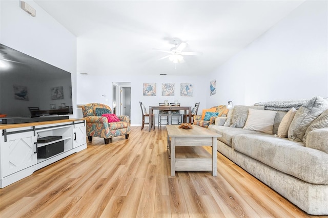 living room featuring ceiling fan and light hardwood / wood-style floors