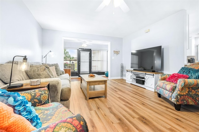 living room featuring ceiling fan and light hardwood / wood-style flooring