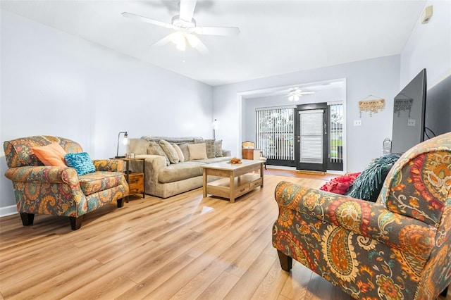 living room with ceiling fan and light wood-type flooring