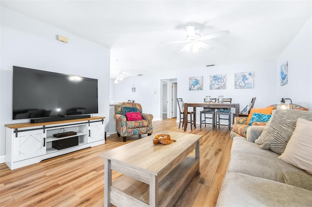 living room featuring hardwood / wood-style floors and ceiling fan