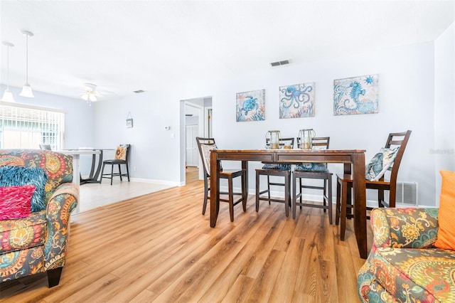 dining room featuring ceiling fan and light hardwood / wood-style flooring