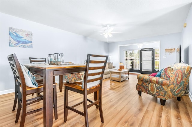 dining room with ceiling fan and light hardwood / wood-style floors