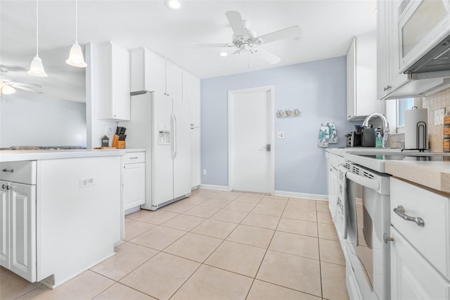 kitchen featuring pendant lighting, light tile patterned floors, white appliances, ceiling fan, and white cabinetry