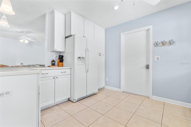 kitchen with light tile patterned flooring, decorative light fixtures, white cabinets, white fridge with ice dispenser, and ceiling fan