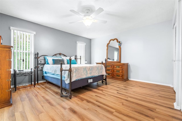 bedroom with ceiling fan and light hardwood / wood-style flooring