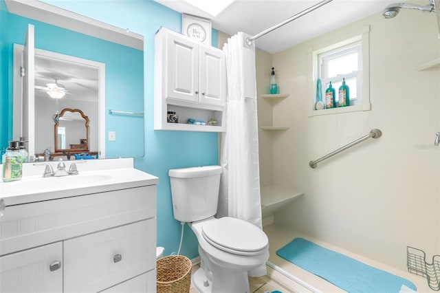 bathroom featuring vanity, toilet, ceiling fan, and a shower with shower curtain