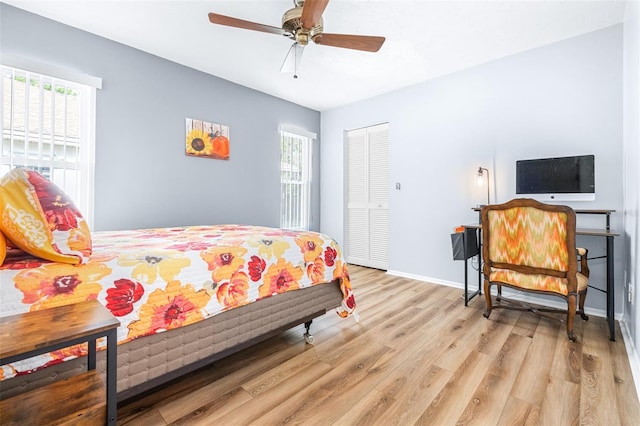 bedroom featuring light hardwood / wood-style floors, a closet, and ceiling fan