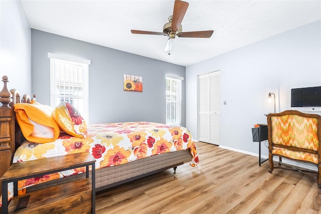 bedroom with a closet, ceiling fan, and light wood-type flooring