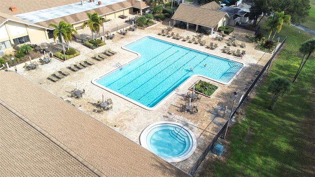 view of swimming pool featuring a hot tub