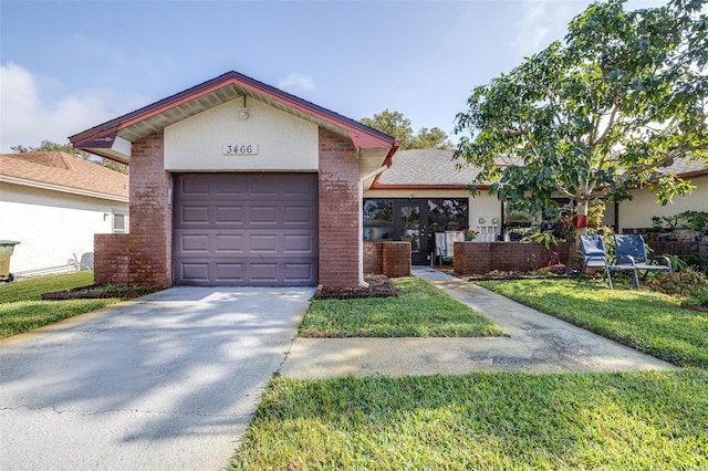 ranch-style home featuring a garage, a front lawn, concrete driveway, and brick siding