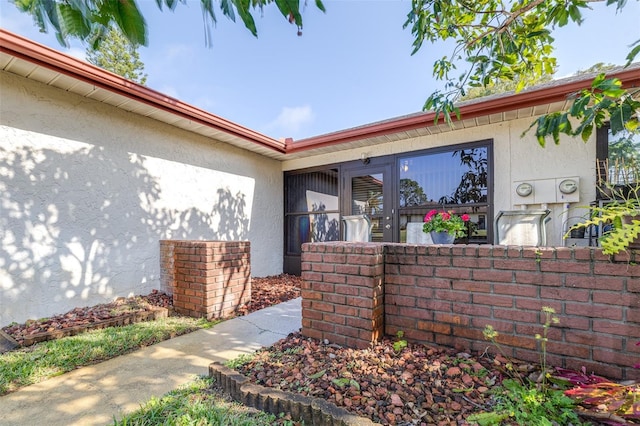 entrance to property with stucco siding