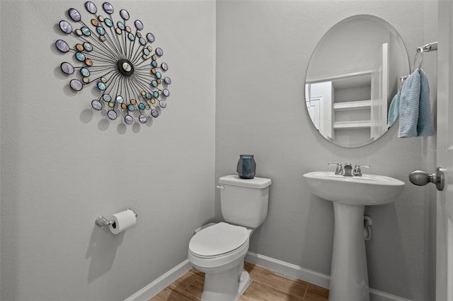 bathroom featuring sink, toilet, and hardwood / wood-style flooring