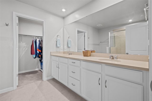 bathroom with tile patterned floors, vanity, and a shower