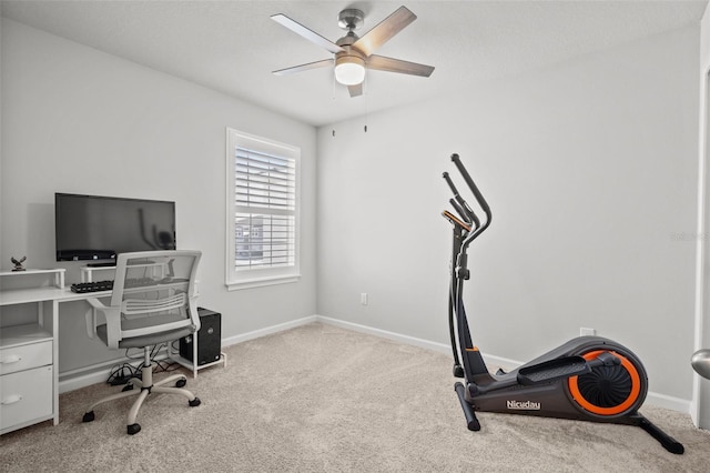 carpeted home office featuring ceiling fan