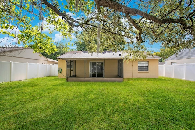 rear view of property with a lawn