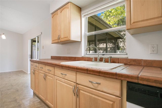 kitchen with tile countertops, dishwasher, sink, and light brown cabinets