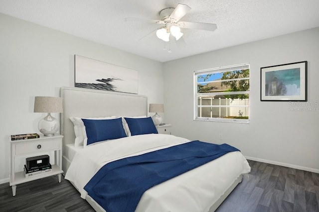 bedroom featuring ceiling fan, dark hardwood / wood-style floors, and a textured ceiling